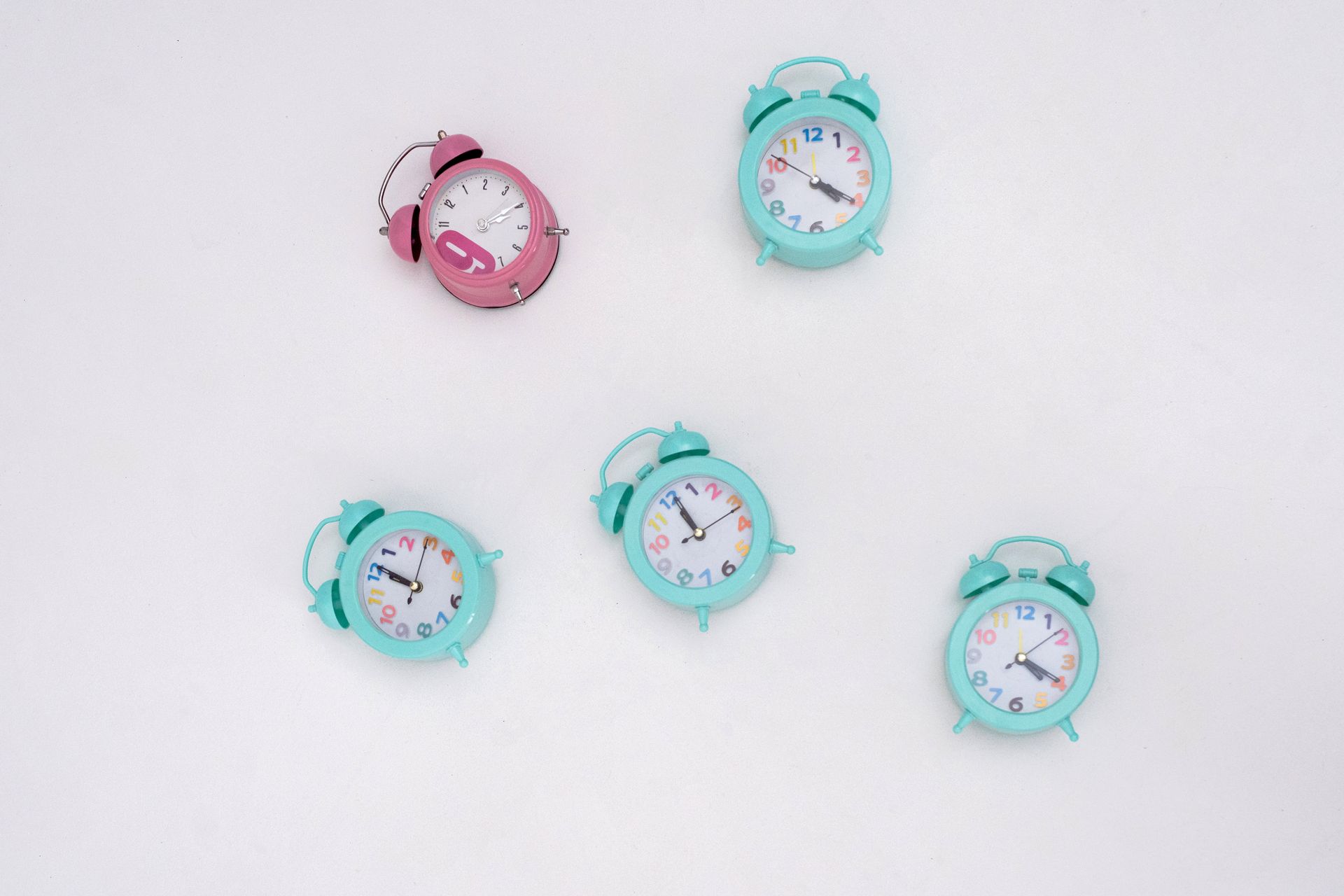 Multiple alarm clocks showing different times — timing decisions in A/B testing