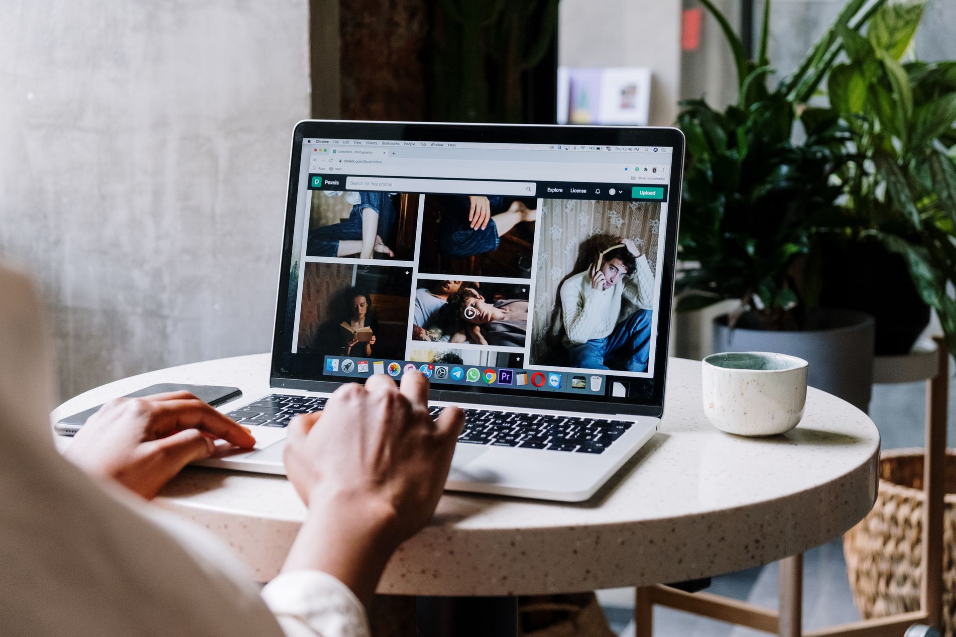 Marketer browsing landing pages on a laptop